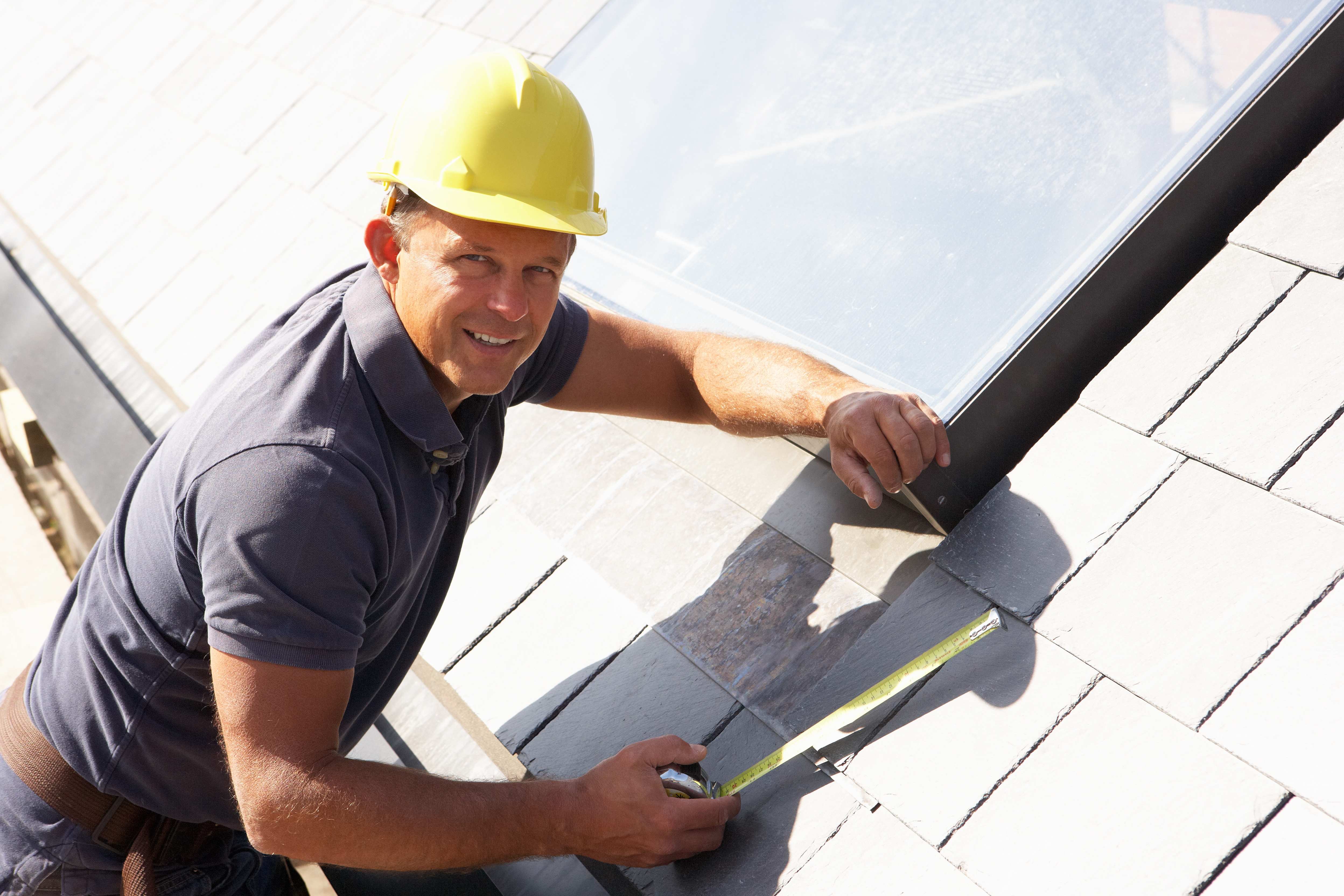 Proof Construction roof replacement - measuring tape and skylight installation