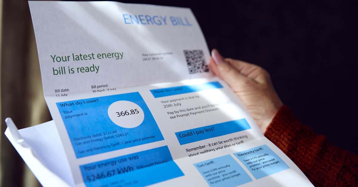Homeowner holding expensive energy bill due to lack of roofing efficiency
