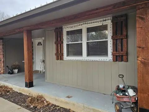 Brick home with new windows and a freshly poured concrete walkway
