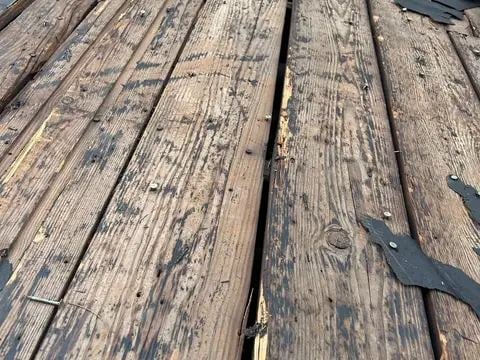 Exposed wood decking stripped back during a tear-off