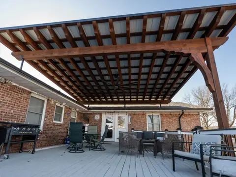 Stained wood pergola covering a backyard patio