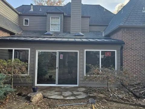 New sunroom windows on a brick home