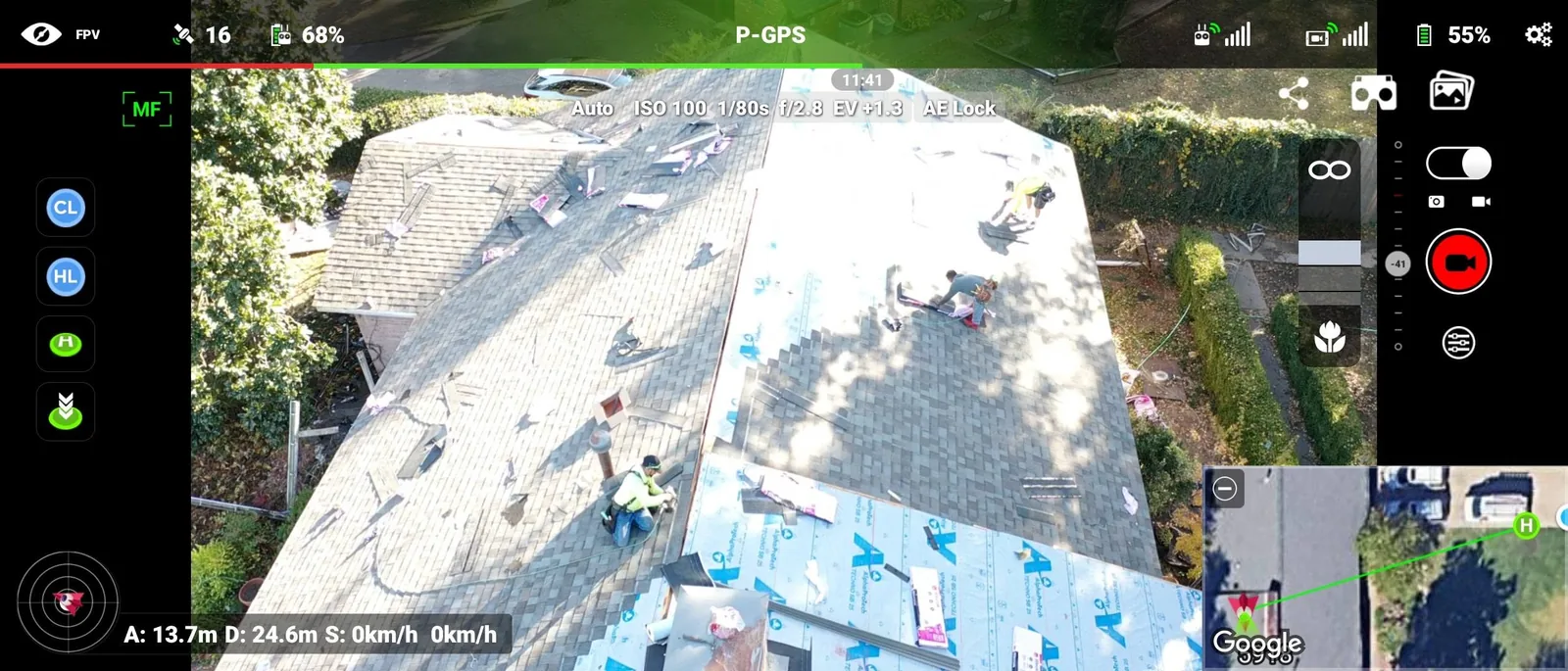 A drone captures roofers working on a house, with a map overlay showing the location.