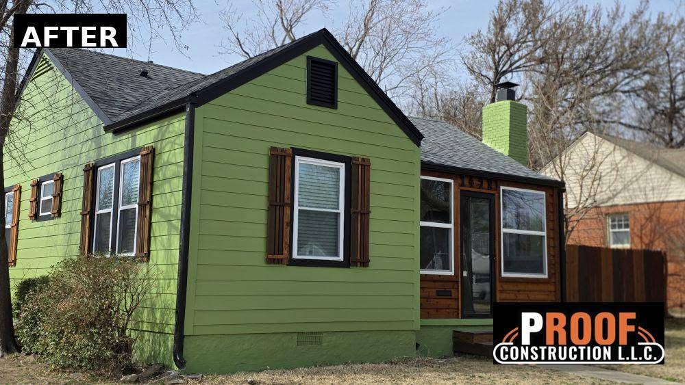 A renovated green house with wooden shutters and a logo for Proof Construction LLC.
