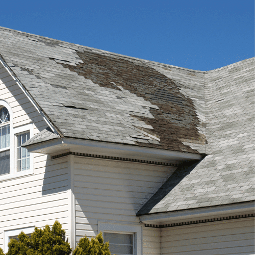 Residential roof with damaged shingles