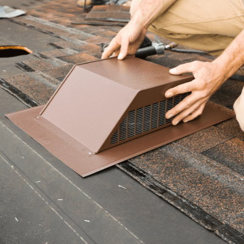 Roof contractor inspecting roof ventilation system