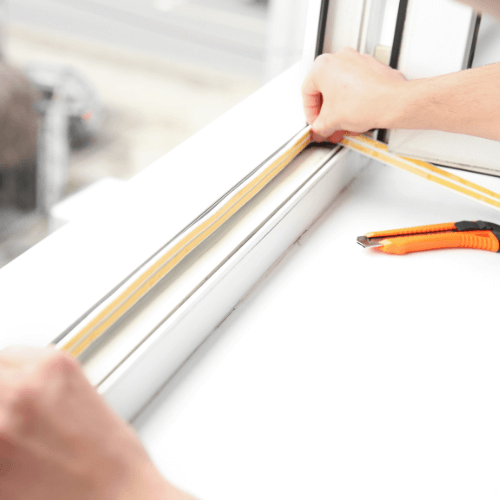 Contractor adding window flashing sealant